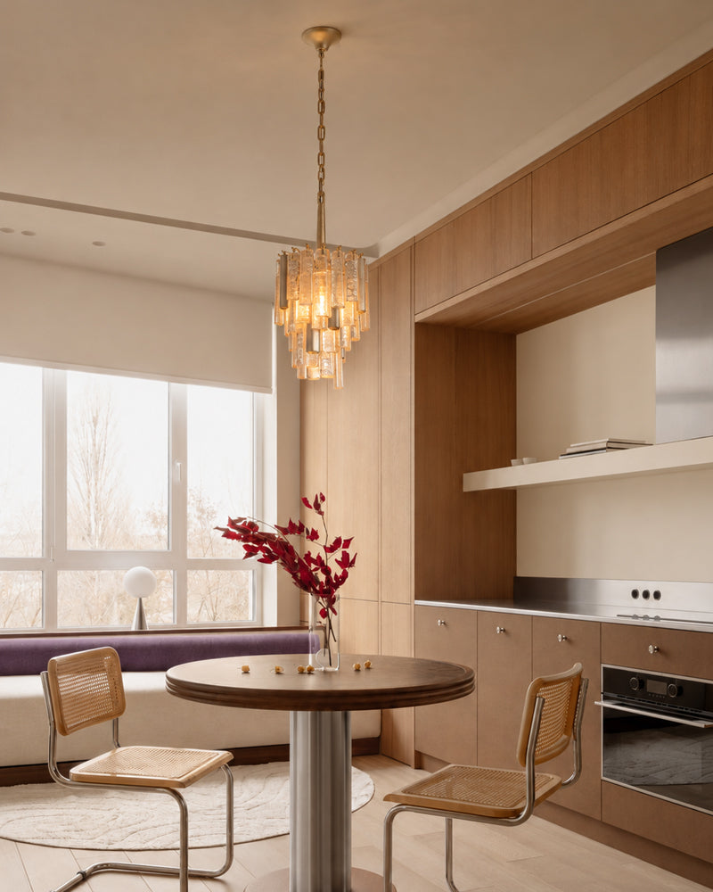 Brass crystal prism pendant light with warm glowing multi-tier glass body
