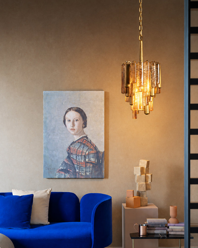 Brass crystal prism pendant light with warm glowing layered glass and hanging chain