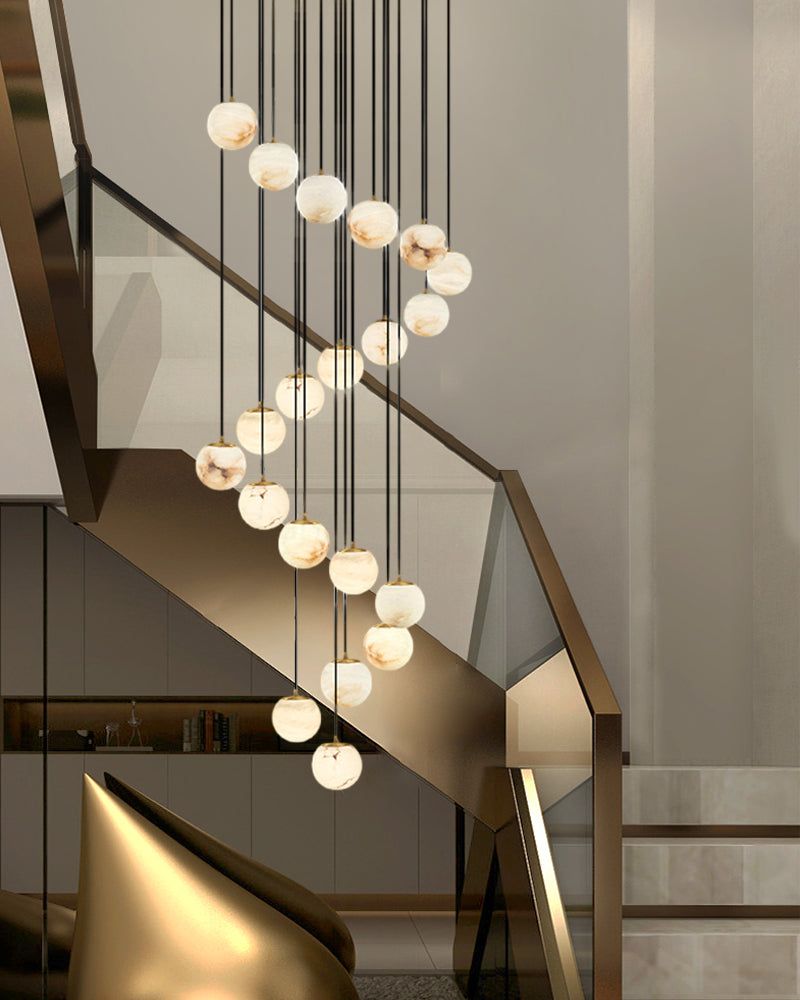 Elegant 22-light marble pendant lamps illuminating modern staircase interior.