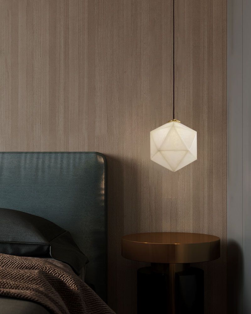 Hexagonal alabaster pendant lamp over modern green bed and black nightstand.
