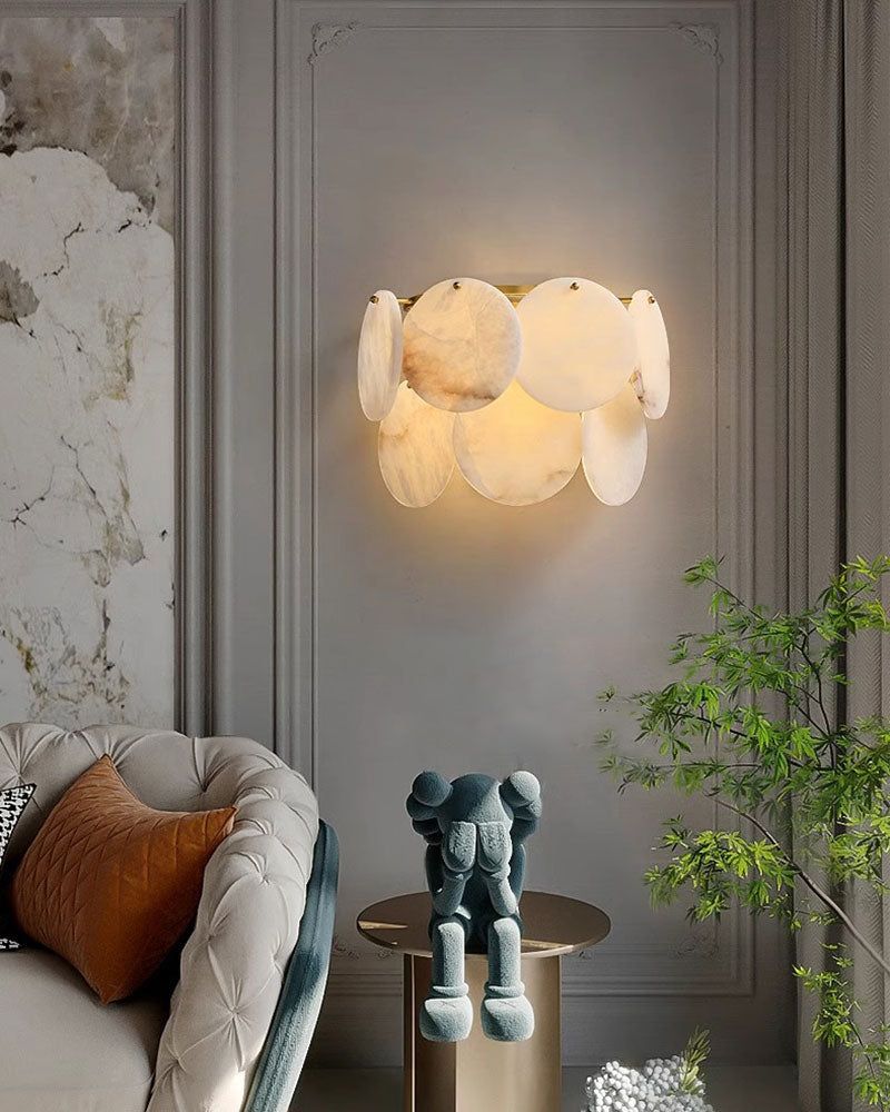 Elegant wall lamp with Spanish marble shells illuminating a chic living room.