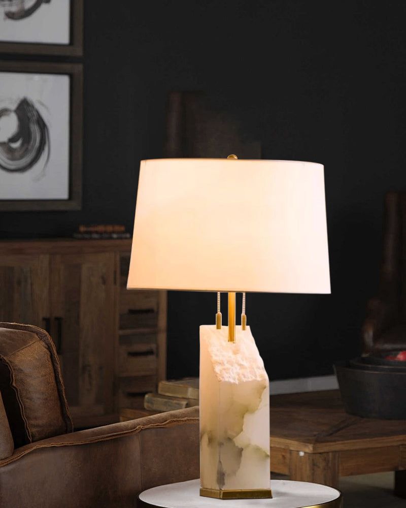 15" white alabaster table lamp with linen shade on a marble side table