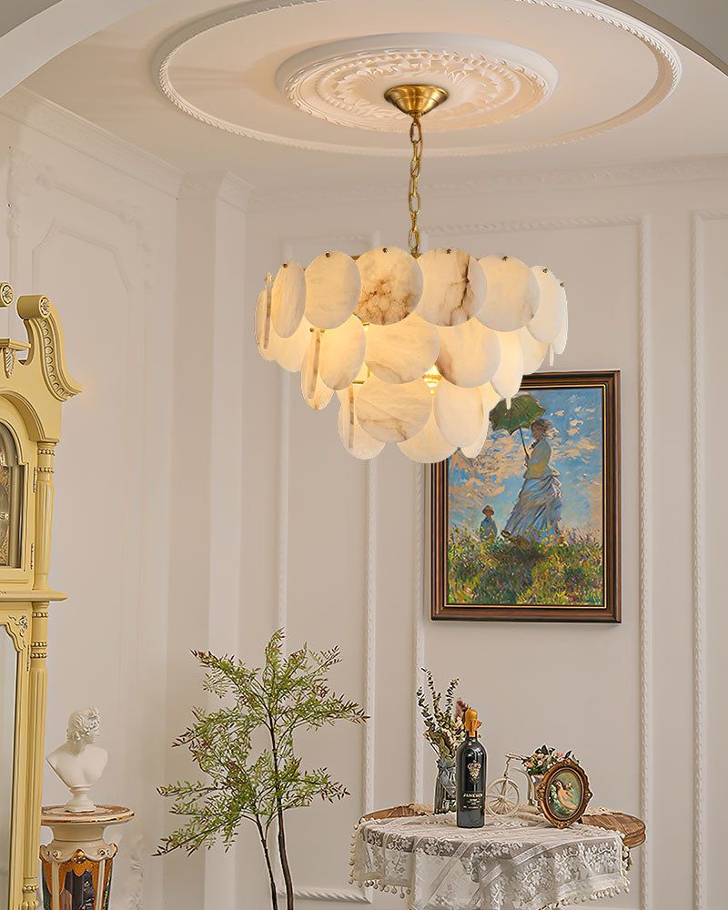 Elegant Spanish marble shell chandelier illuminating a stylish room with decorative table.