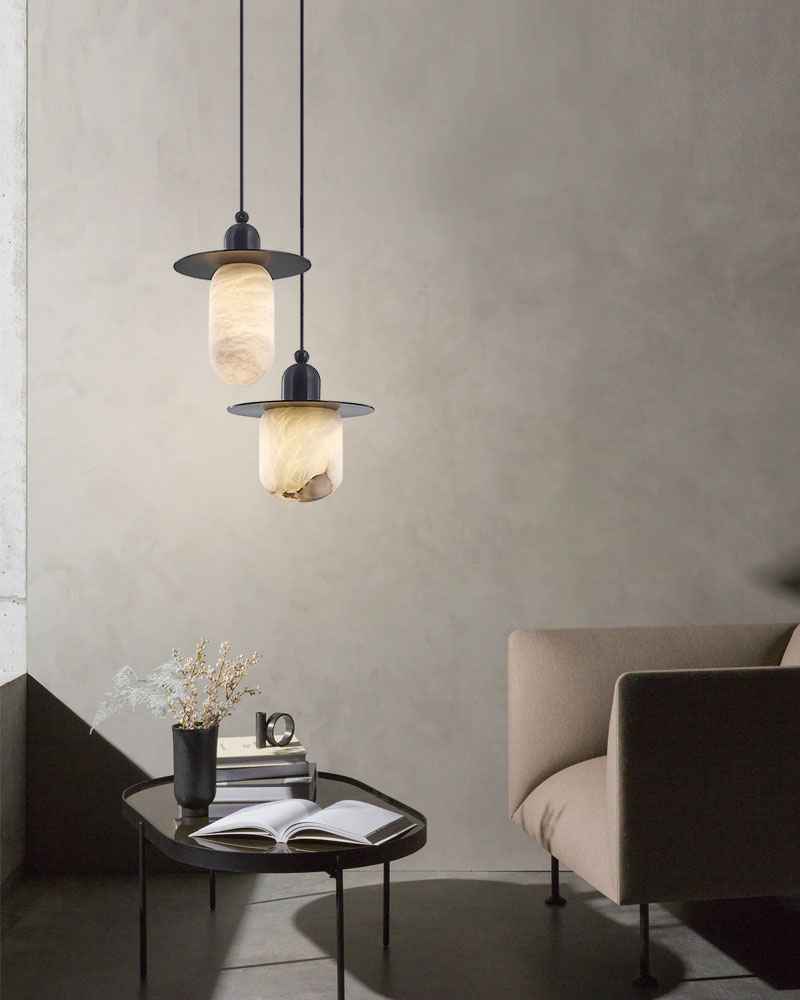 Stylish alabaster pendant lamps above coffee table in a modern living room