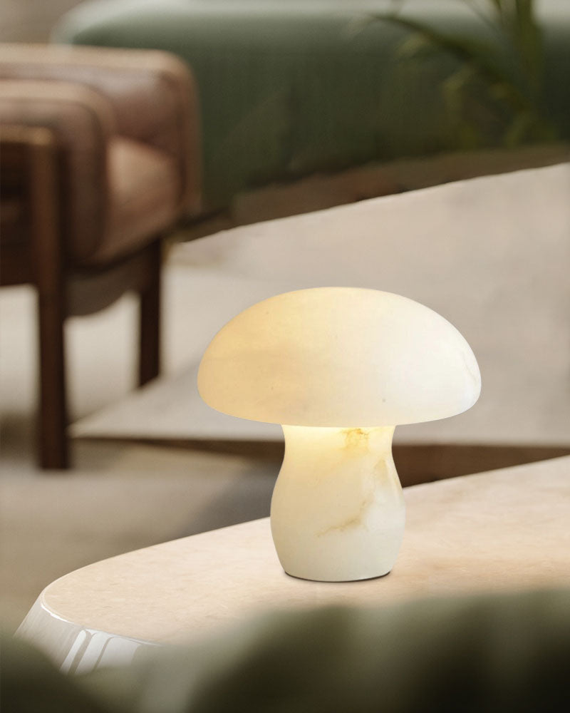 Cozy white mushroom lamp emitting warm light on marble table in elegant interior.