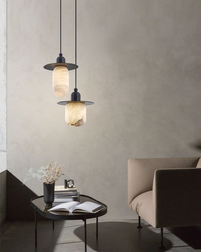 Stylish alabaster pendant lamps above coffee table in a modern living room