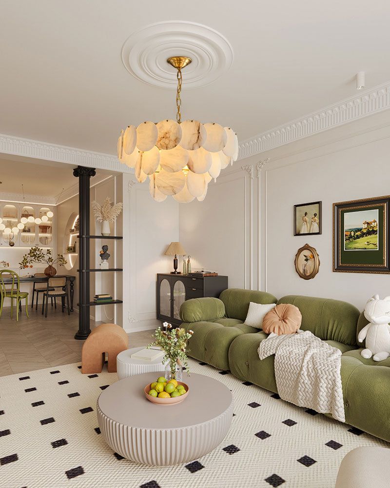 Long linear chandelier with Spanish marble shells illuminating a chic living room.