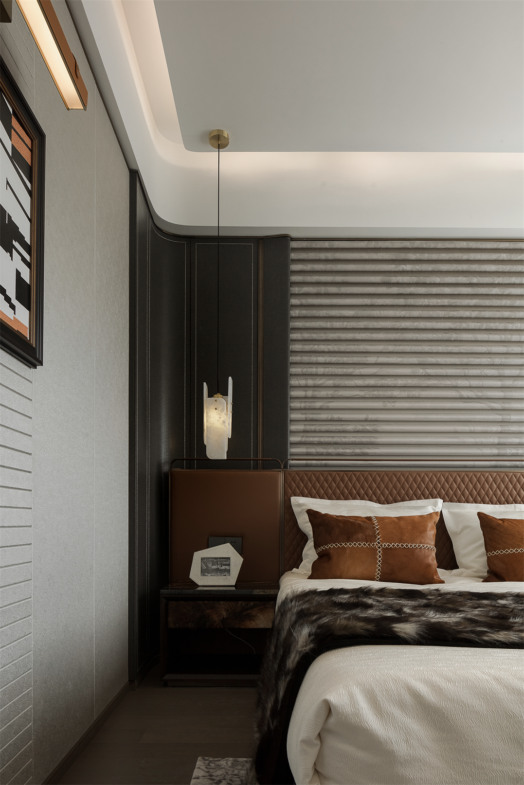 Stylish bedroom with leather headboard and alabaster pendant light.