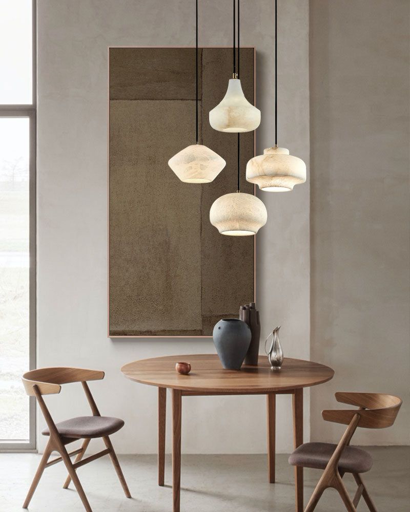 Contemporary dining space with multiple alabaster pendant lights and a round wooden table