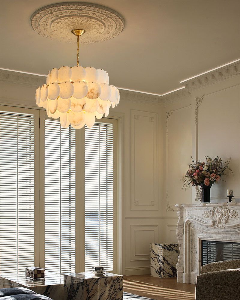 Long linear LED chandelier with Spanish marble shells above a modern marble table.