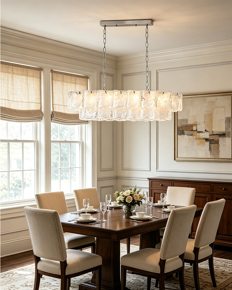 Linear chandelier with frosted white glass tubes and hanging chain suspension over dining table