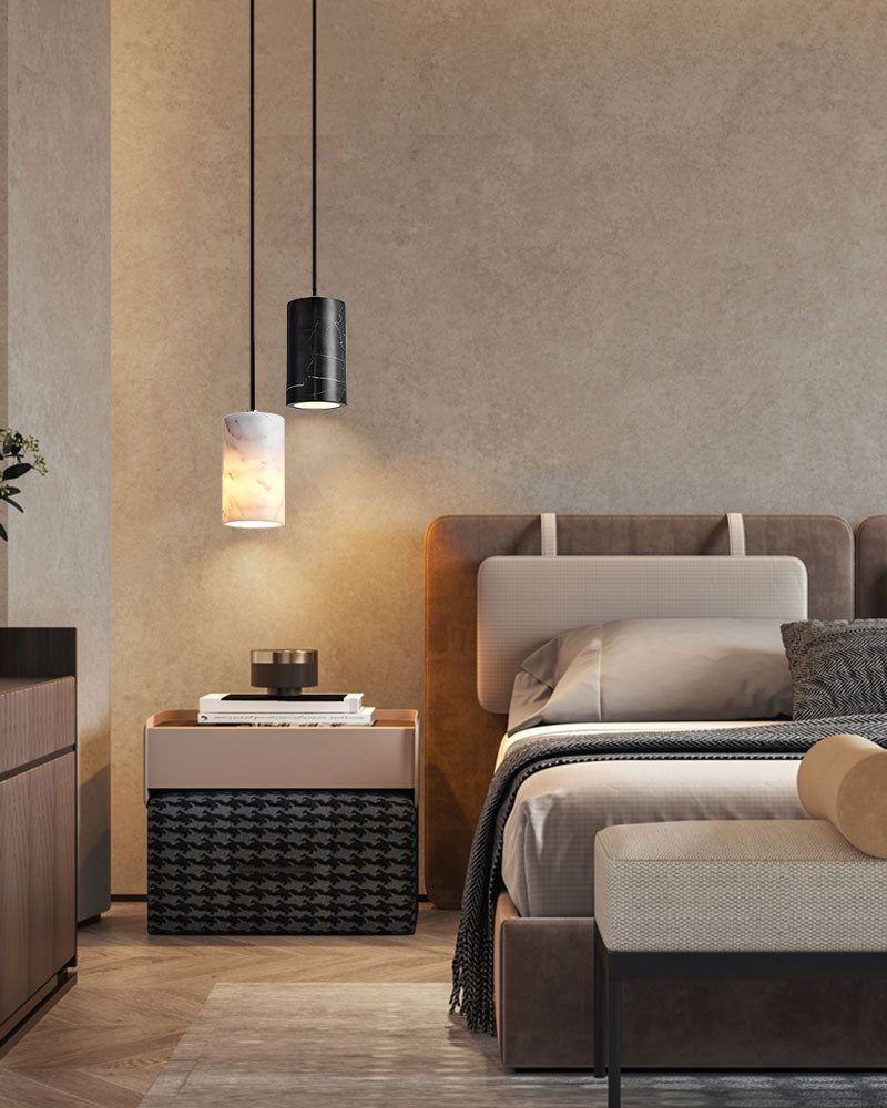 Modern bedroom with a pendant lamp pair above a stylish bed and nightstand.
