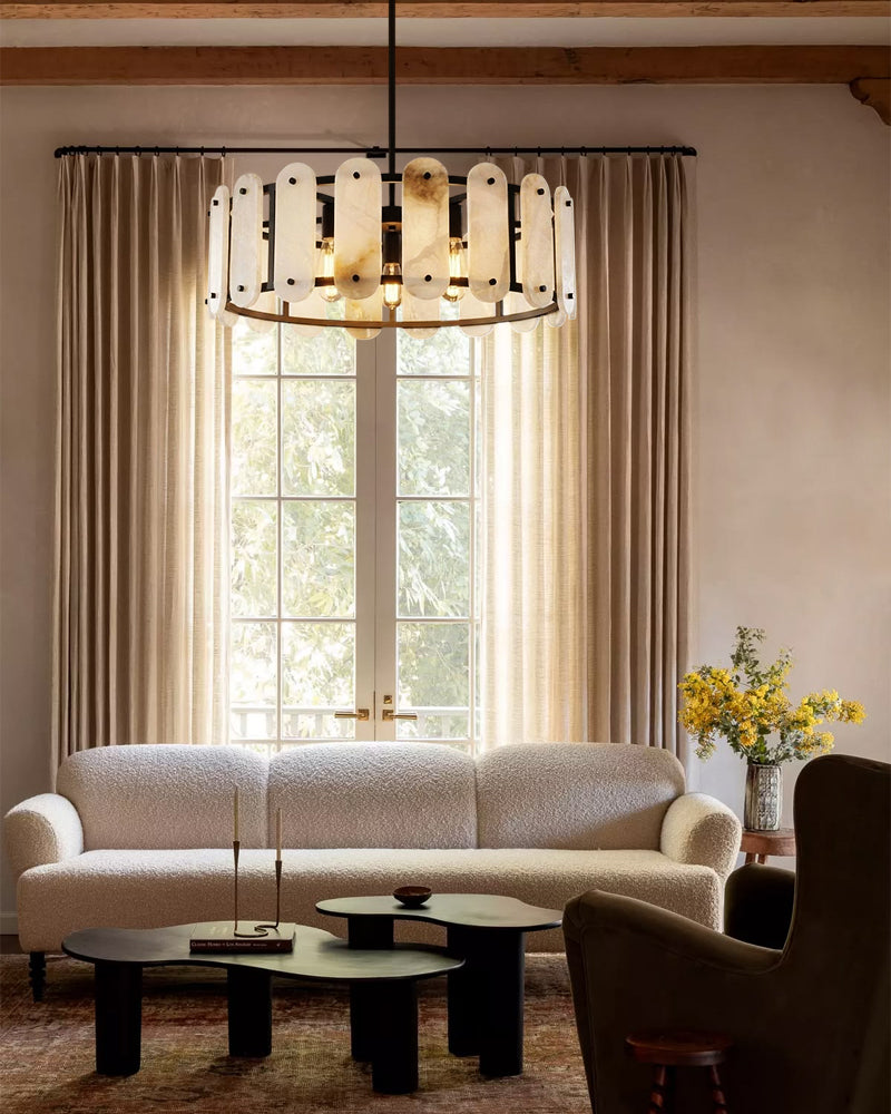 Oval alabaster pendant light with black trim and a dark ceiling rod