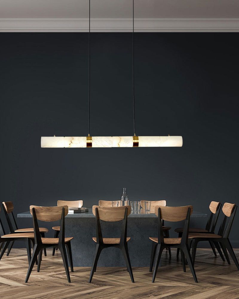Alabaster LED pendant lamp over a dark table with wooden chairs in a modern dining room.