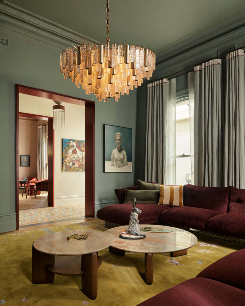 Brass multi-tier crystal prism chandelier with warm-lit hanging glass cylinders