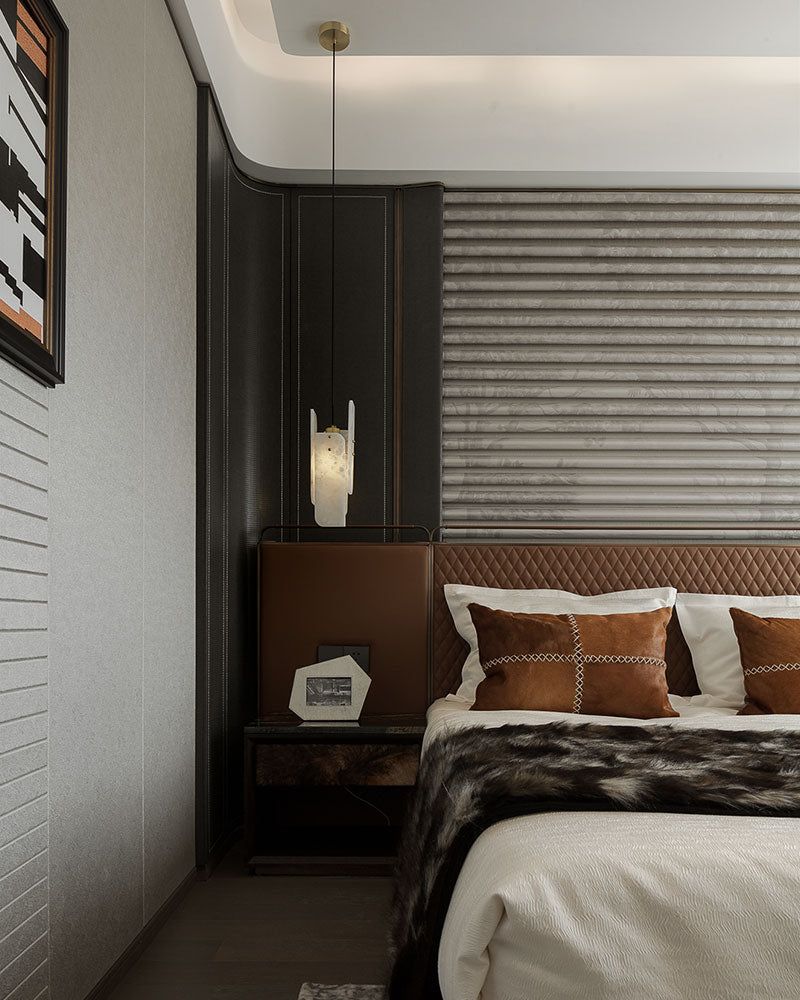 Elegant bedroom featuring a brown leather headboard and alabaster pendant lamp.