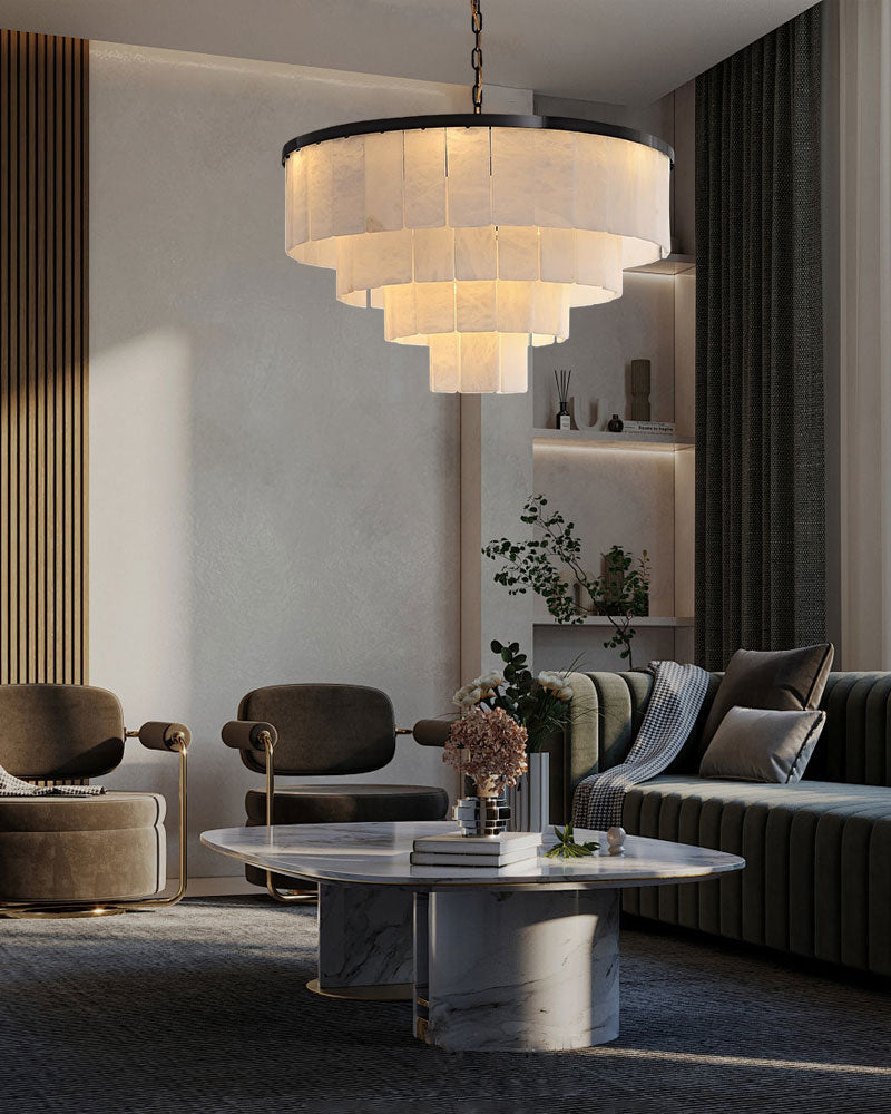 Modern living room with layered marble chandelier and round marble coffee table.