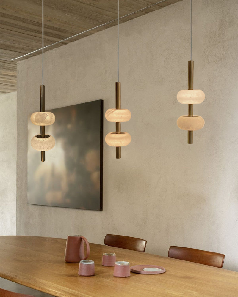 Modern pendant lights hanging above a dining table.