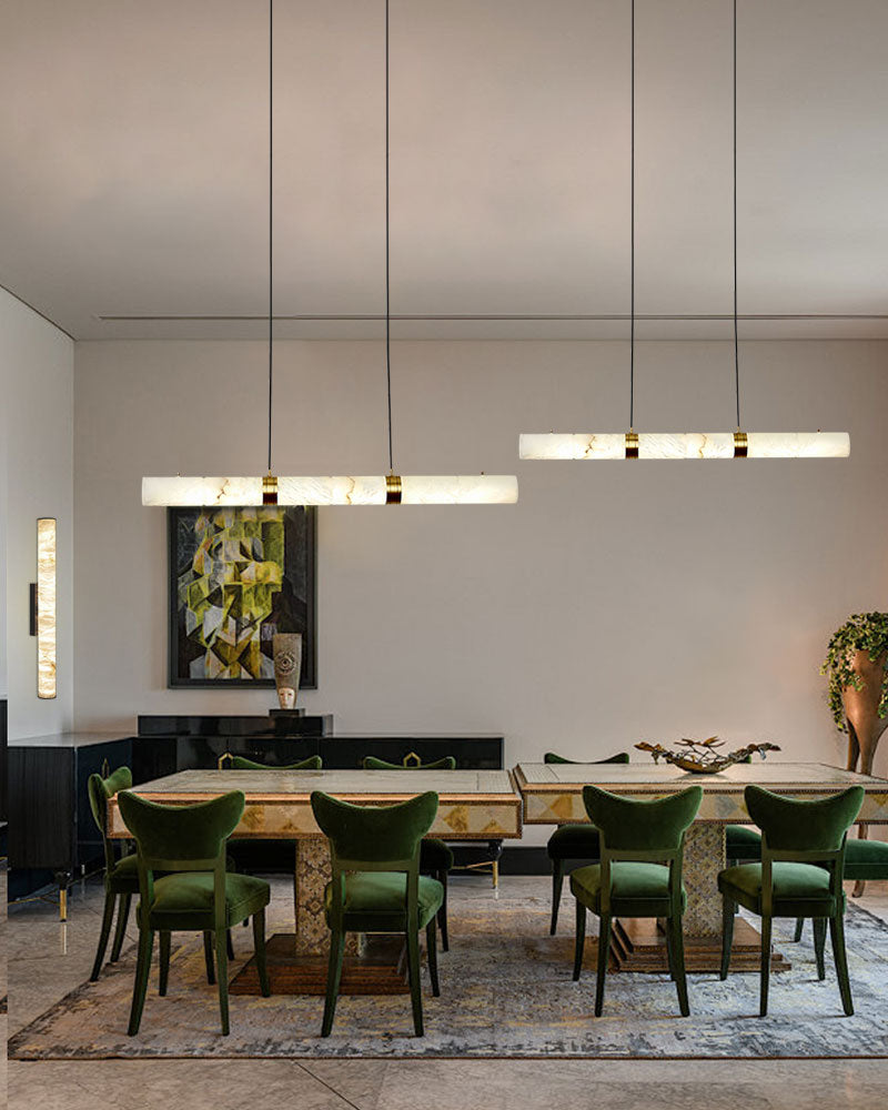 Modern dining room with green chairs and alabaster pendant lamps