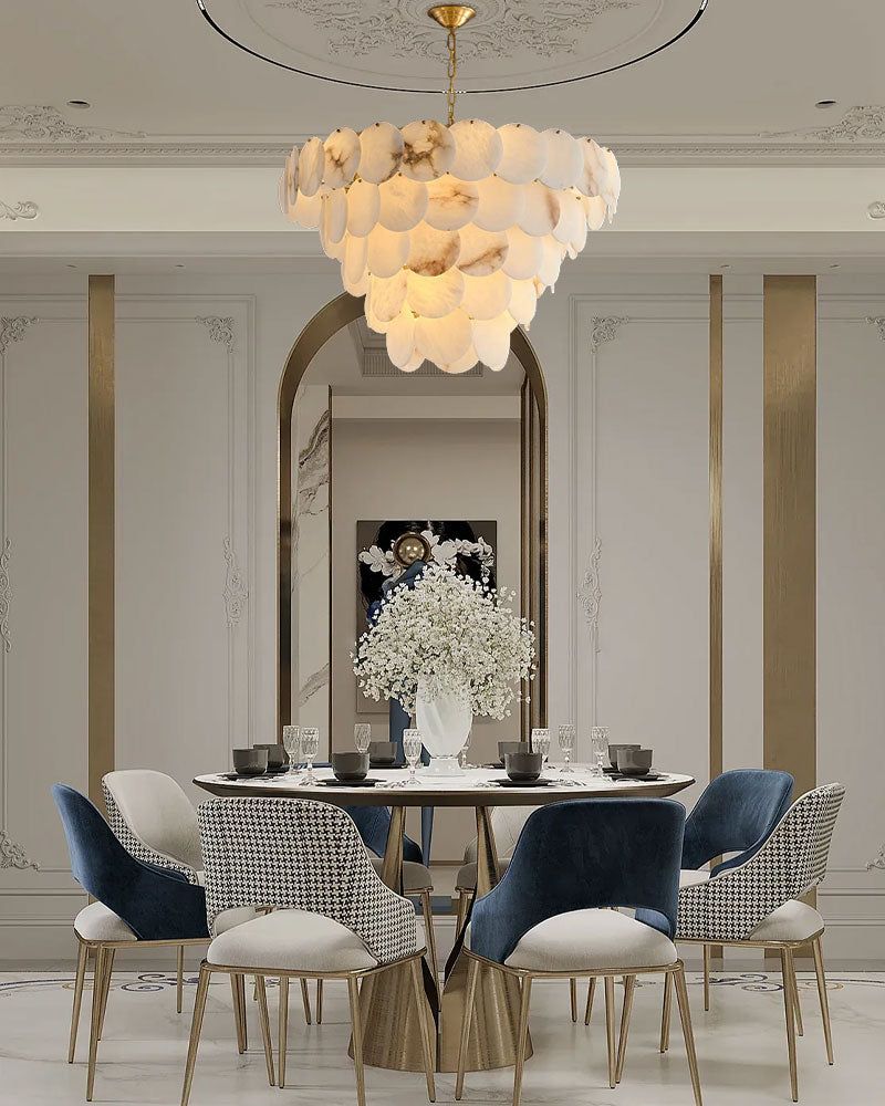 Elegant long linear chandelier with Spanish marble shell over a stylish dining table.