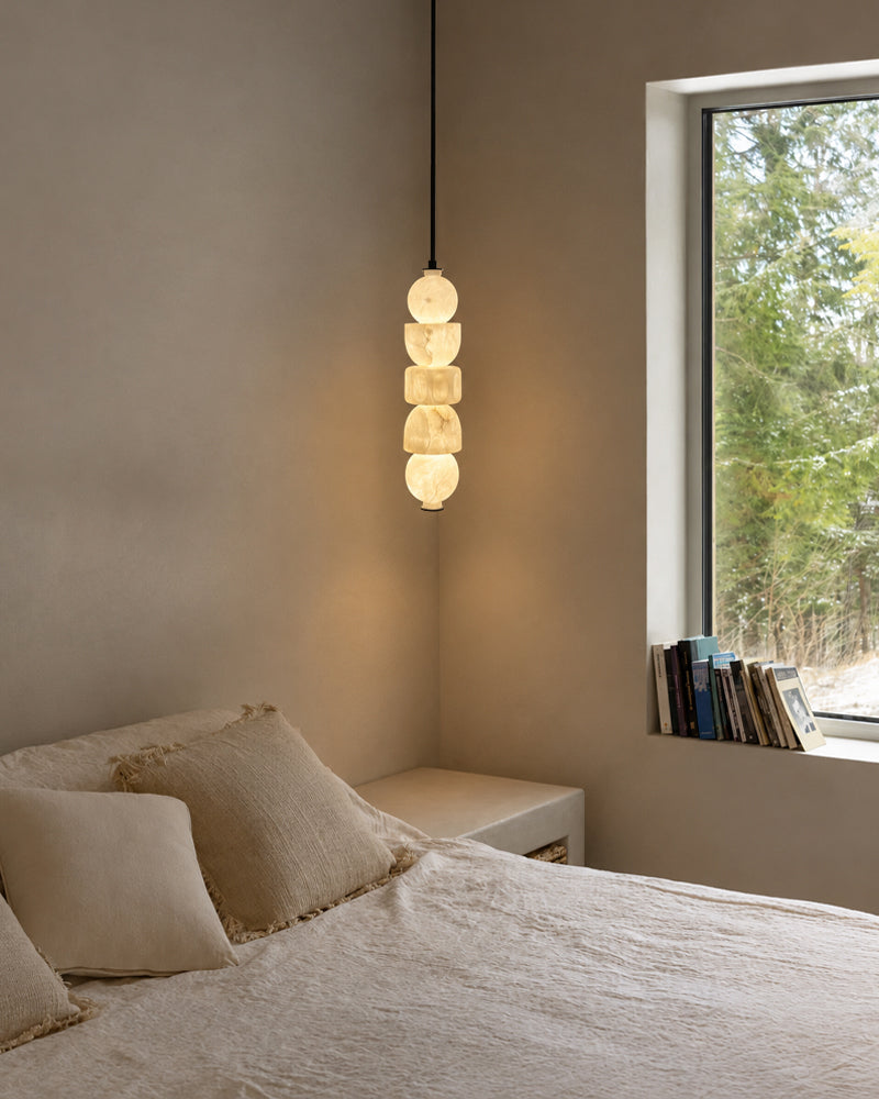Small globe pendant light with stacked alabaster-style glass shades on black cord