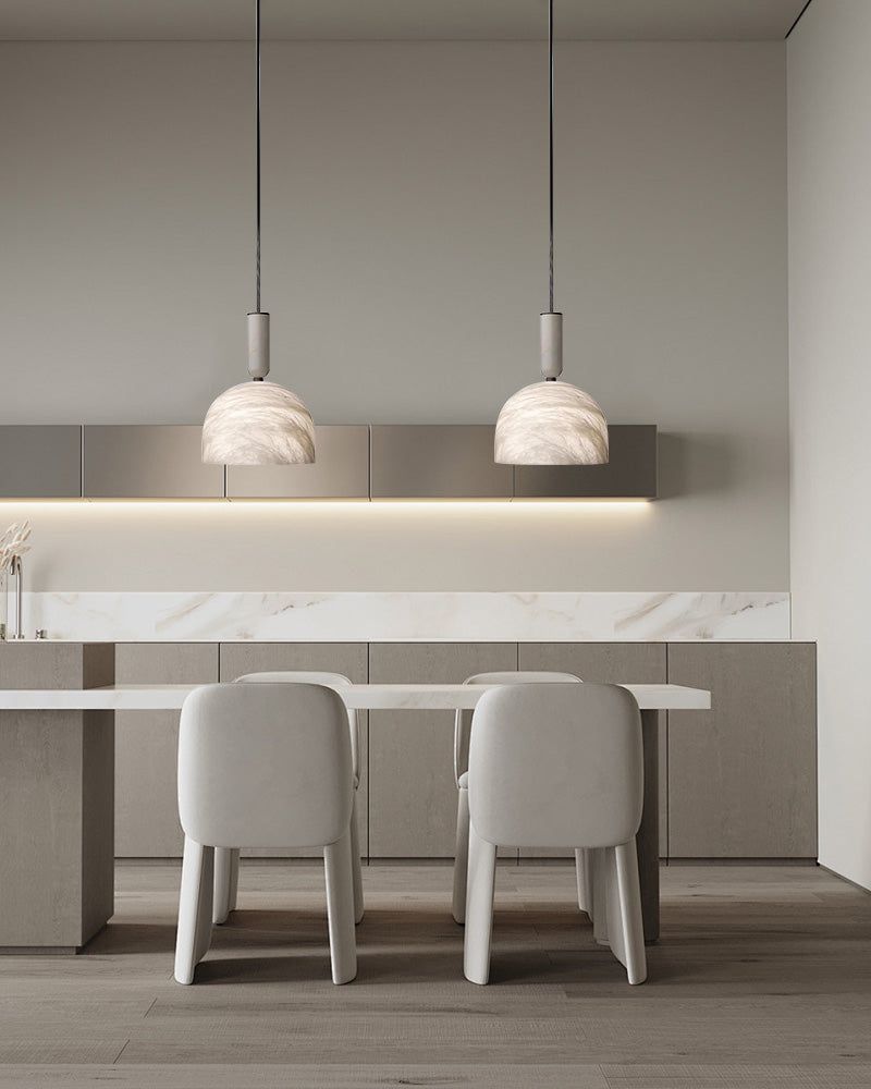 Postmodern LED white marble pendant lights above a minimalist kitchen island.