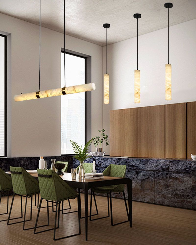 Alabaster LED pendant lamp above modern dining table with green chairs and dark accents.