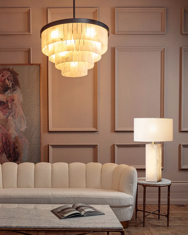 Modern living room with layered marble chandelier and cozy cream sofa.