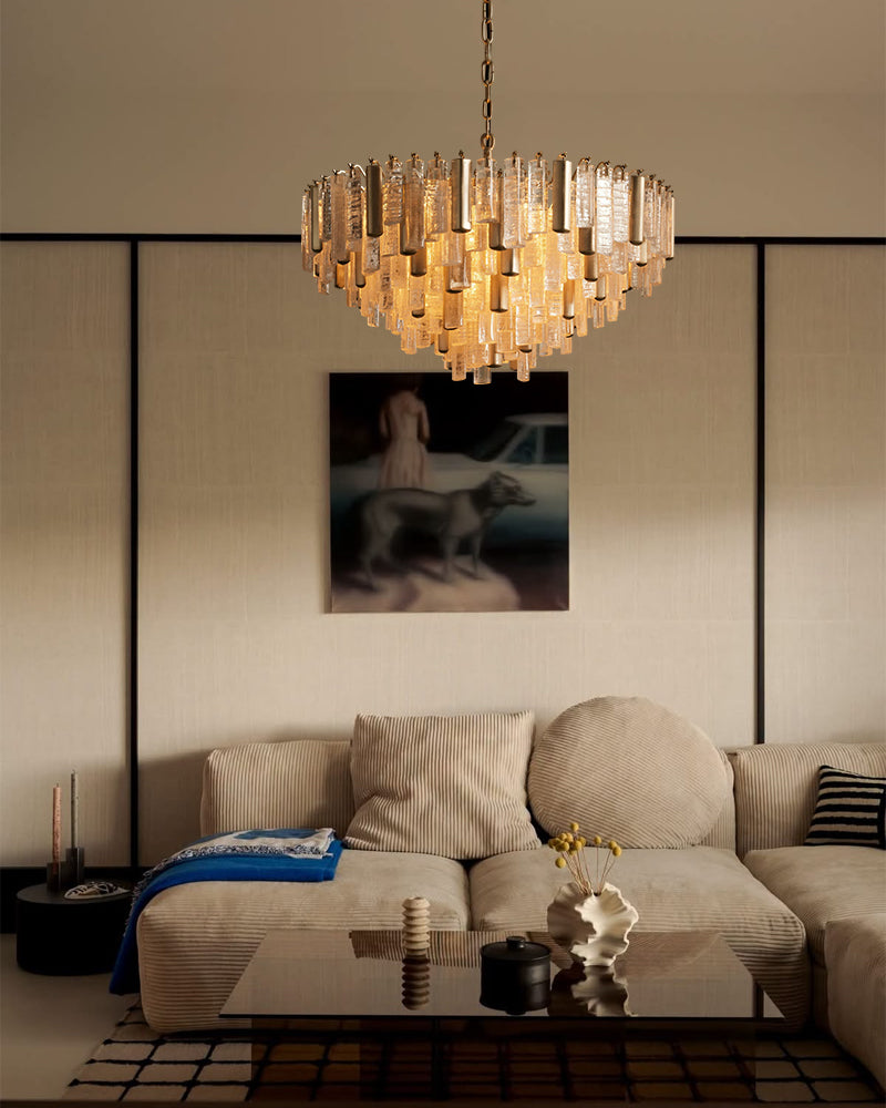 Brass multi-tier crystal prism chandelier centered above seating area