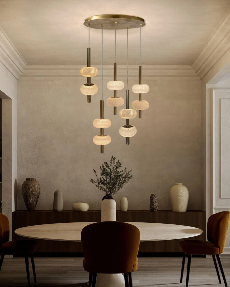 Modern chandelier hanging above a dining table in a stylish room.