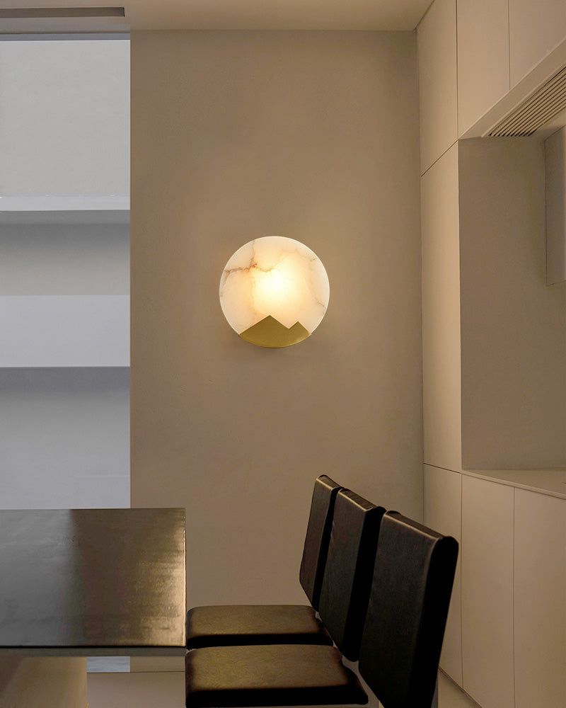 Alabaster marble LED wall sconce with mountain shape in stylish dining area