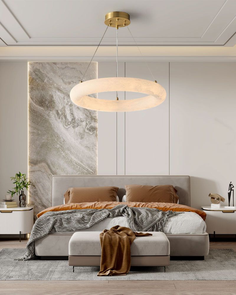 Alabaster pendant light illuminates modern bedroom with cozy bed and neutral decor