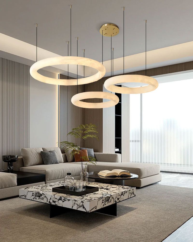 Contemporary living room with circular pendant lights over marble coffee table and gray sofa