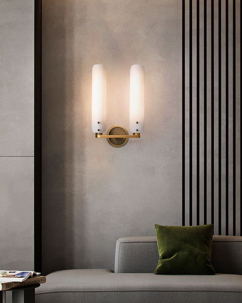 Curved brass wall sconce lamp with milk glass shades in contemporary living room design