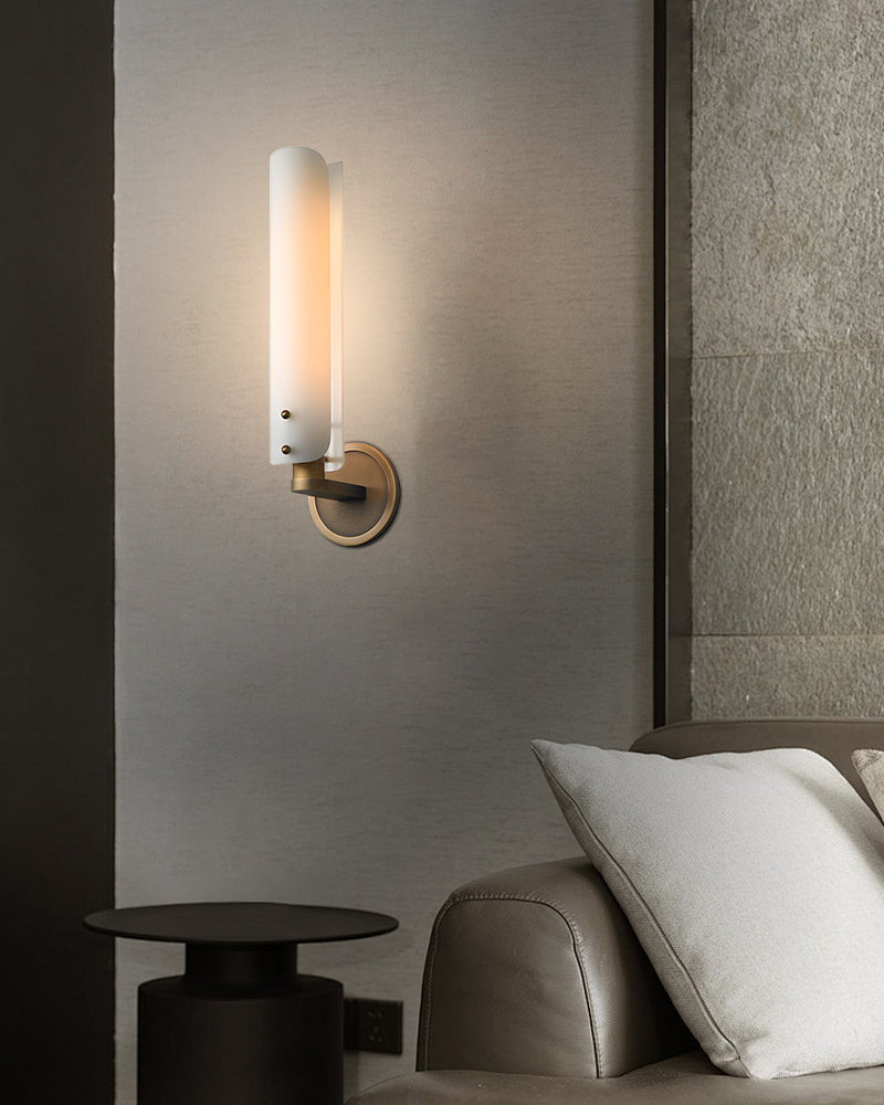Curved milk glass wall sconce lamp with brass mount in modern living room decor