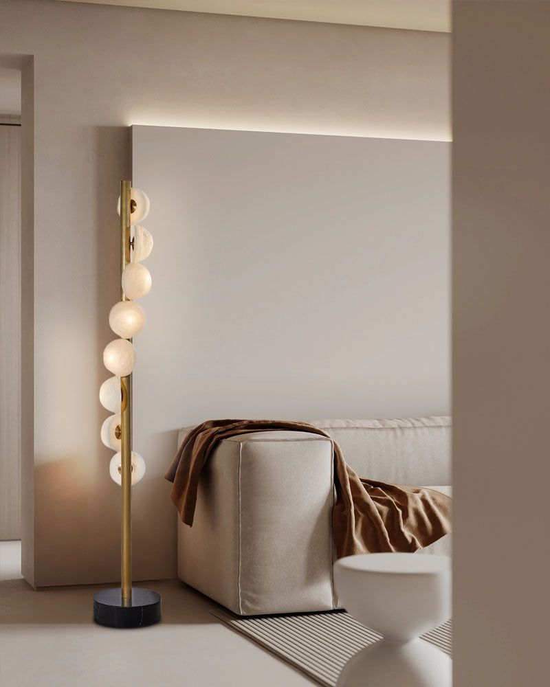 Elegant brass floor lamp with alabaster globes in a minimalist living space