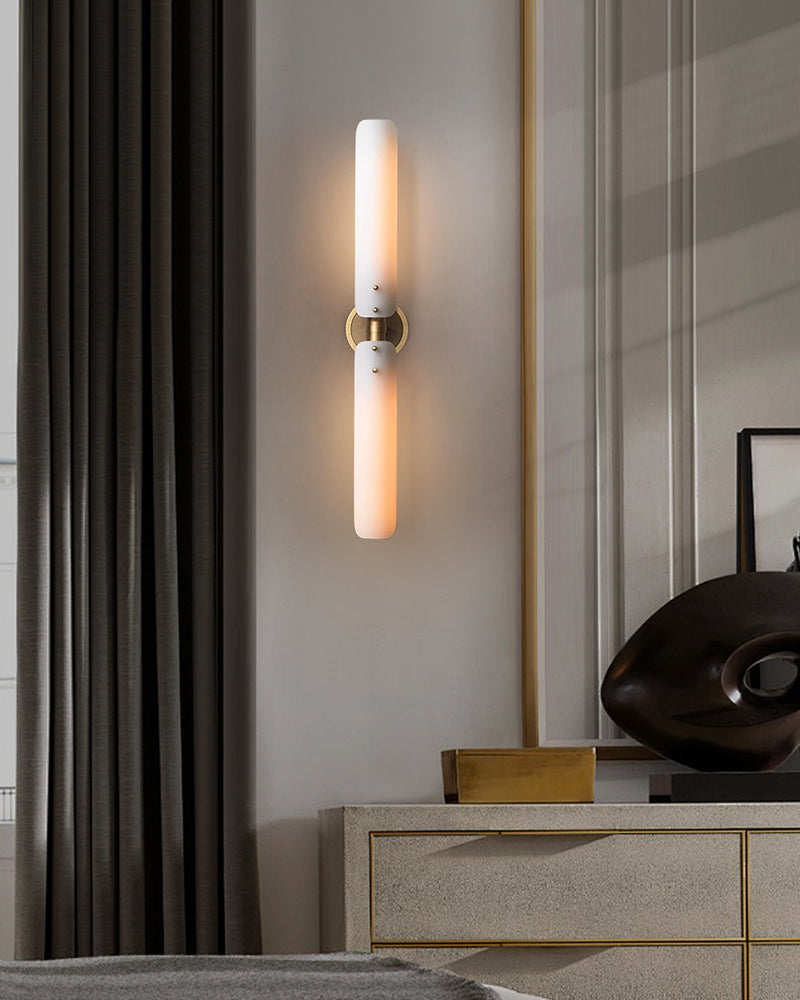 Elegant milk glass wall sconce lamp with brass fixtures in modern bedroom decor