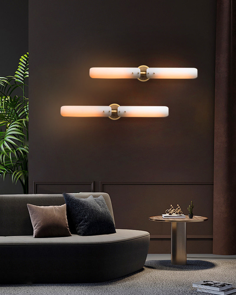 Elegant milk glass wall sconces with brass fixtures illuminating modern living room decor