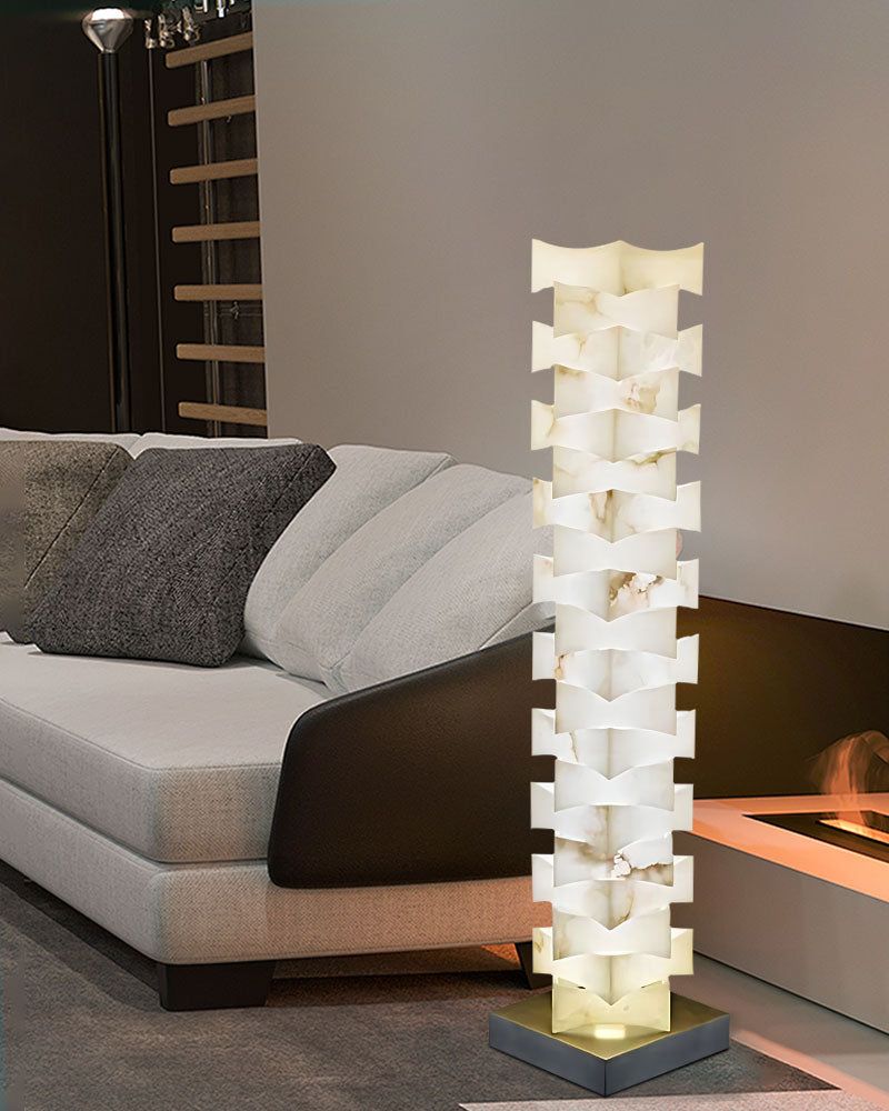 LED floor lamp with alabaster shade beside gray sofa in contemporary living room