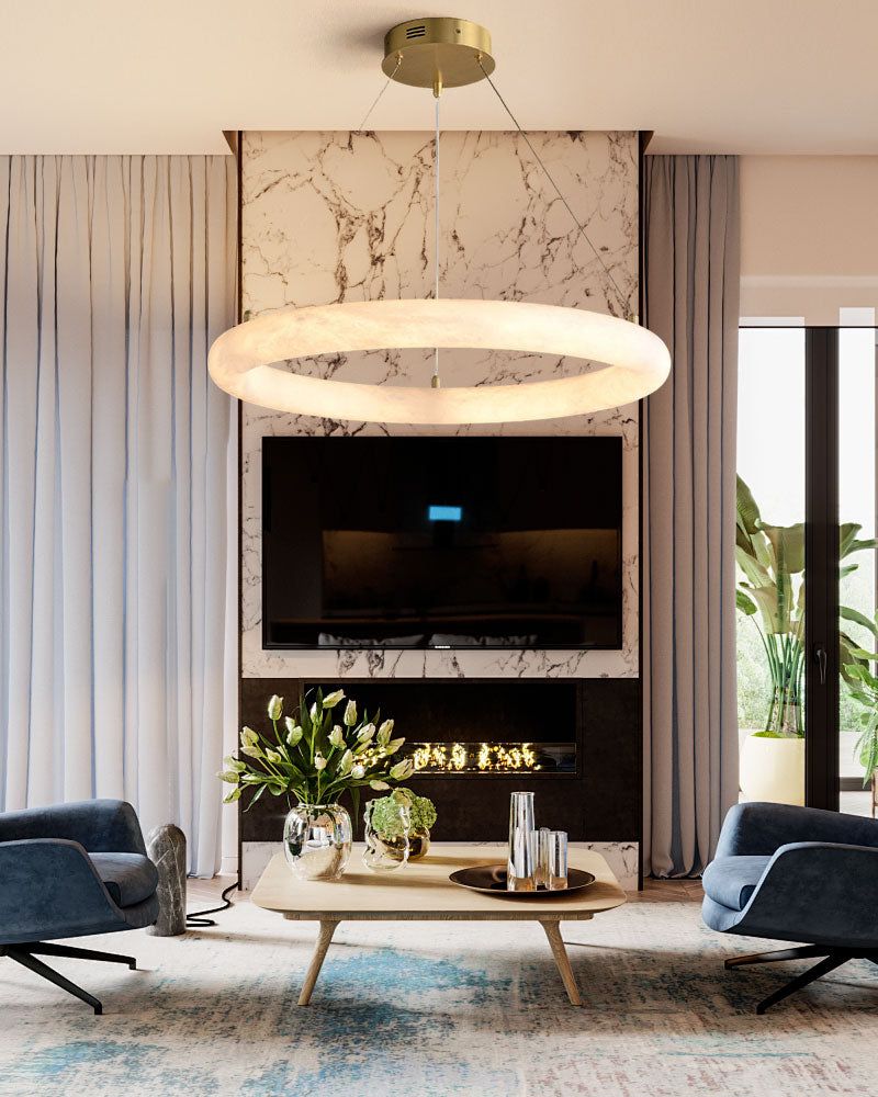 Modern living room with circular pendant light above marble fireplace and blue armchairs