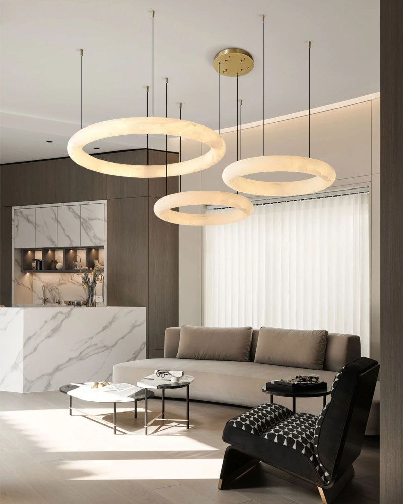 Modern living room with three circular alabaster pendant lights above stylish coffee table