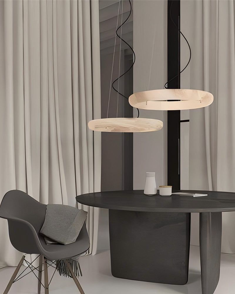 Sleek black dining table with oval wooden pendant lights and gray chair in modern decor