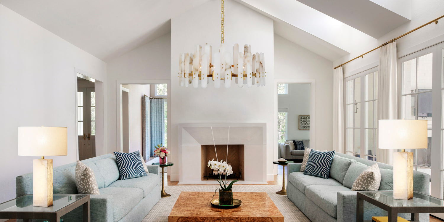 A stylish living room featuring an elegant Living Room Light hanging above a cozy seating area.