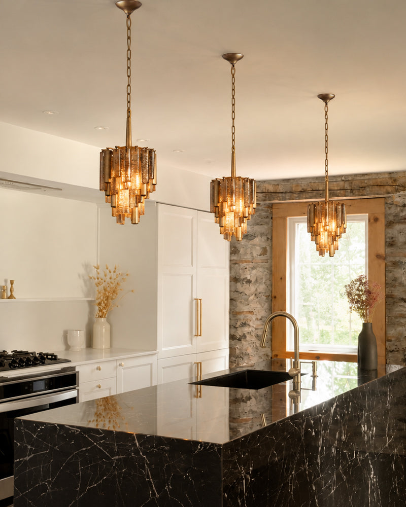 Brass multi-tier crystal prism pendant light with warm glowing glass prisms