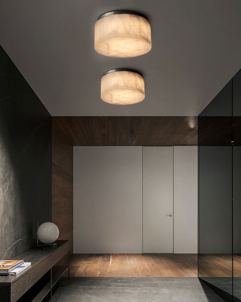 Two alabaster ceiling lights enhancing a stylish hallway with warm illumination.