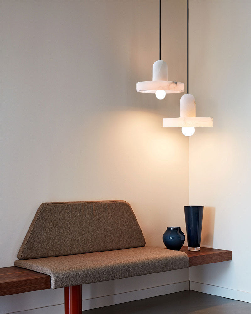 Modern E27 alabaster pendant lights above a wooden bench in a minimalist interior