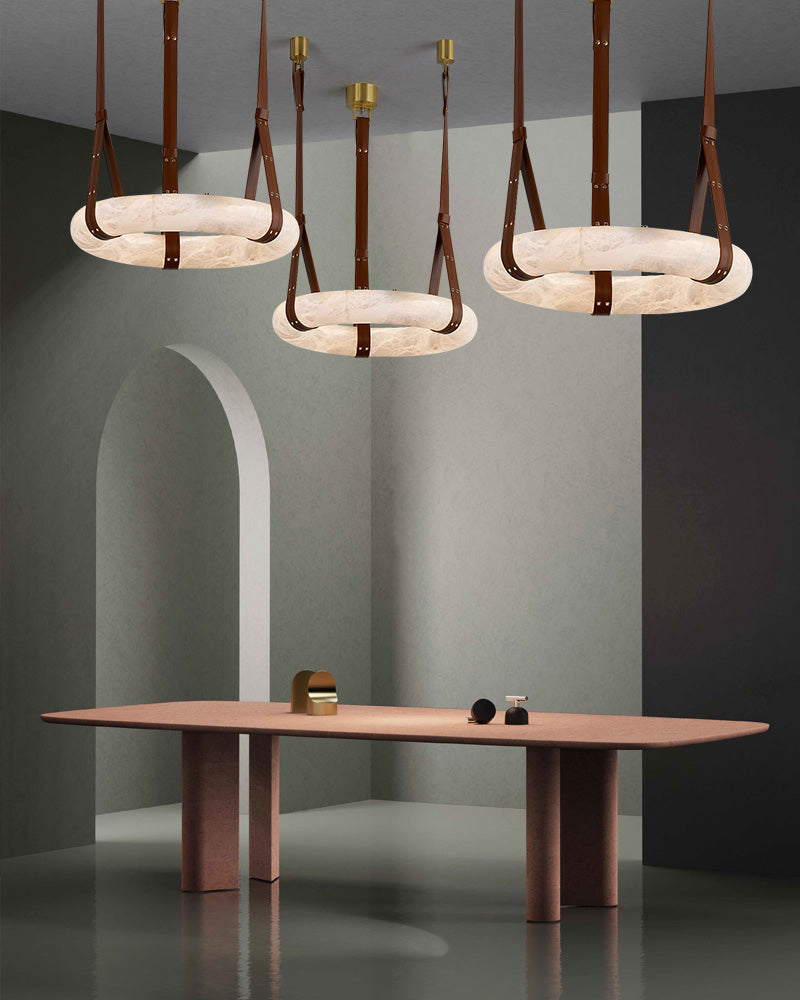 Elegant alabaster LED pendant lamps with leather straps above a stylish dining table.