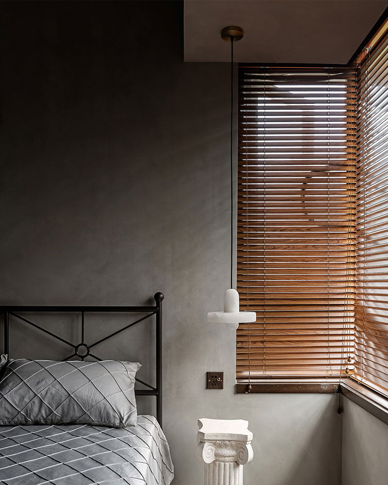 E27 alabaster pendant light beside a bed in a modern bedroom with wooden blinds