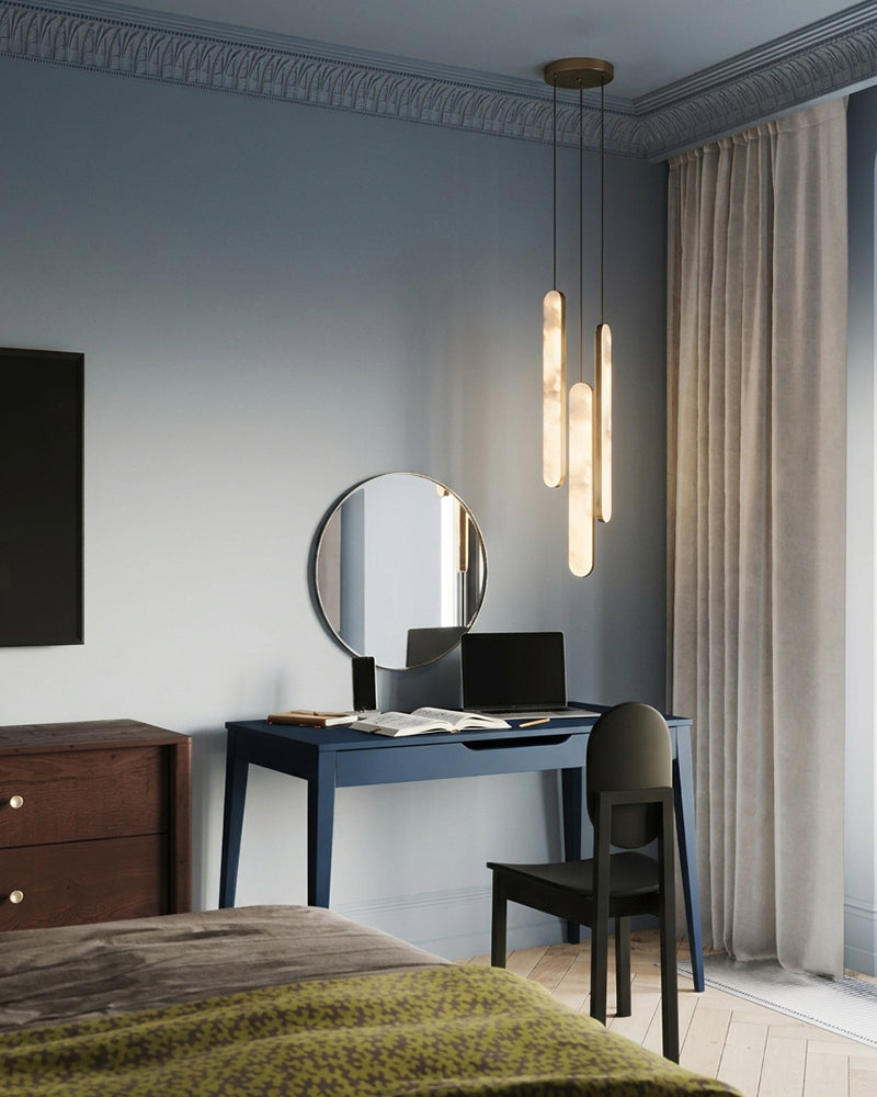Alabaster pendant light with brass trim, warm vertical glass shades