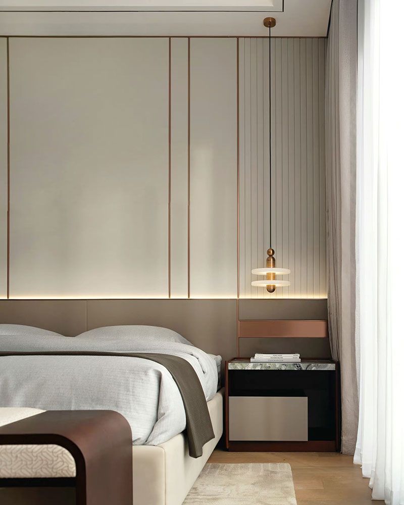 Stylish pendant lamp above modern nightstand in elegant bedroom design.